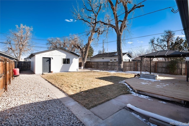 view of yard featuring a gazebo, a storage unit, and a deck