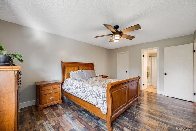 bedroom featuring ceiling fan, connected bathroom, a textured ceiling, and dark hardwood / wood-style flooring