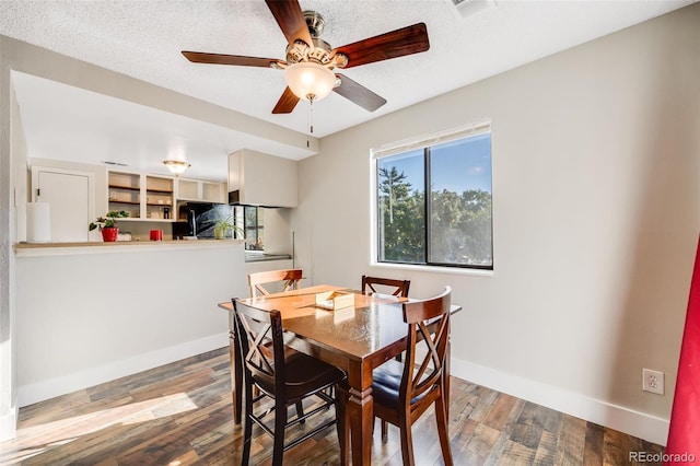 dining area featuring hardwood / wood-style floors, a textured ceiling, and ceiling fan