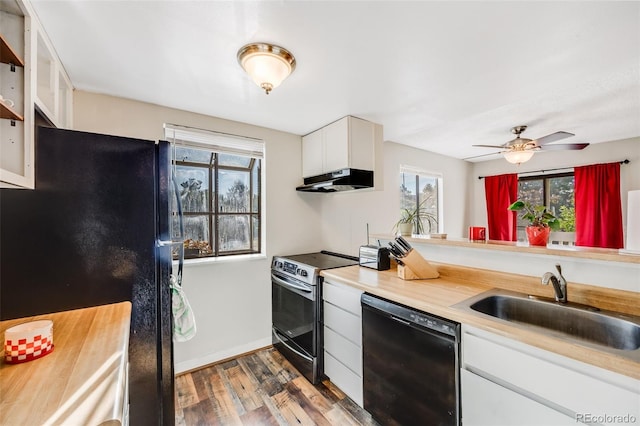 kitchen with dark hardwood / wood-style flooring, sink, black appliances, and white cabinets