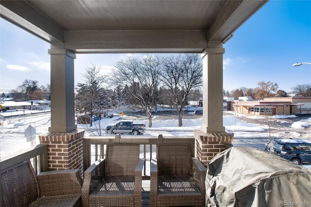 snow covered patio with covered porch