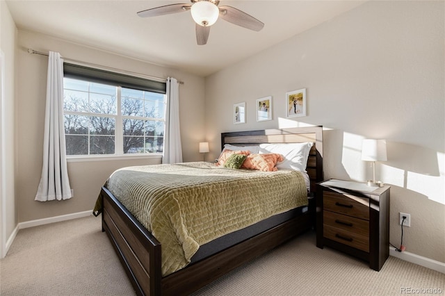 bedroom with light colored carpet, baseboards, and ceiling fan