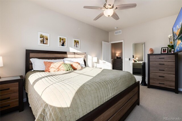 bedroom featuring visible vents, light colored carpet, and a ceiling fan