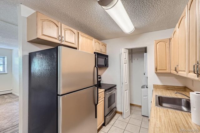 1400 Golden Cir Unit 102, Golden, CO 80401 - kitchen featuring stainless steel appliances, light brown cabinets, a textured ceiling, light tile patterned floors, and light countertops