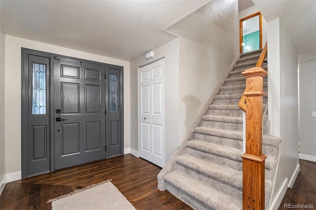 17540 Caribou Dr, Monument, CO 80132 - entrance foyer with baseboards, stairway, and dark wood-type flooring