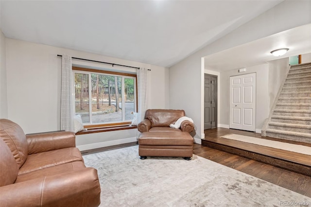 17540 Caribou Dr, Monument, CO 80132 - living room featuring dark wood-style floors, stairway, baseboards, and vaulted ceiling