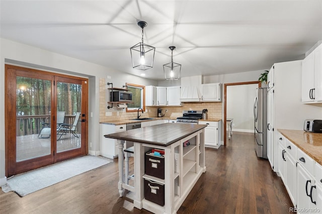 17540 Caribou Dr, Monument, CO 80132 - kitchen featuring stainless steel appliances, open shelves, a sink, and backsplash