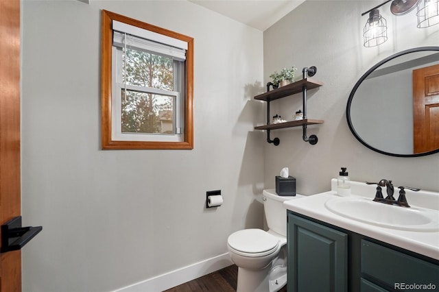 17540 Caribou Dr, Monument, CO 80132 - half bath with toilet, vanity, wood finished floors, and baseboards