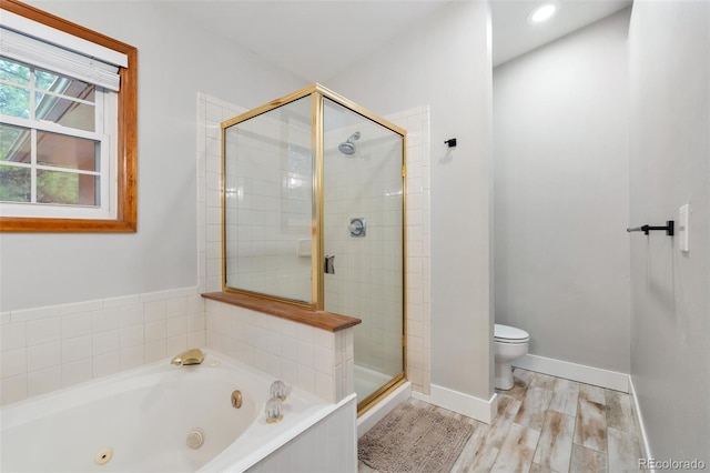 17540 Caribou Dr, Monument, CO 80132 - full bath with a stall shower, a jetted tub, toilet, wood finished floors, and baseboards