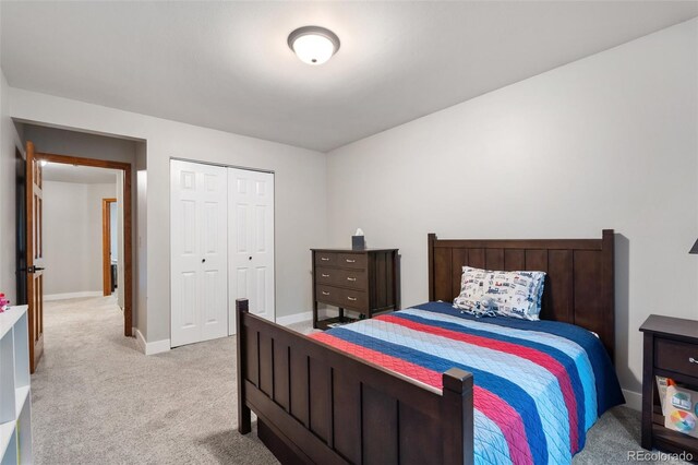 17540 Caribou Dr, Monument, CO 80132 - bedroom featuring light colored carpet, a closet, and baseboards