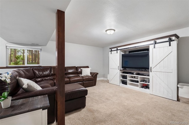 17540 Caribou Dr, Monument, CO 80132 - carpeted living area featuring a barn door and baseboards