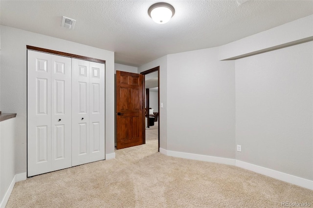 17540 Caribou Dr, Monument, CO 80132 - unfurnished bedroom featuring carpet flooring, baseboards, a closet, and a textured ceiling