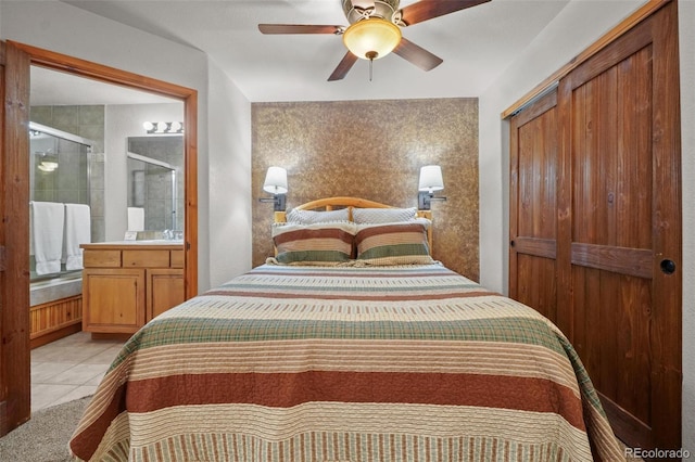 bedroom with a closet, light tile patterned flooring, sink, and ceiling fan