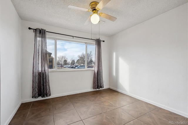 spare room featuring ceiling fan and a textured ceiling