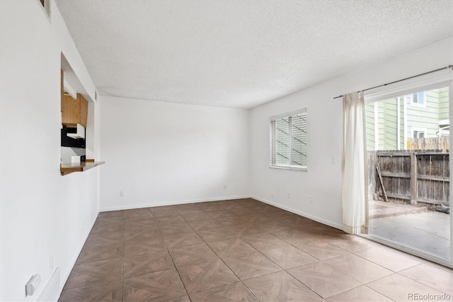 spare room with a textured ceiling