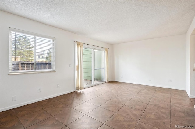 spare room with a textured ceiling