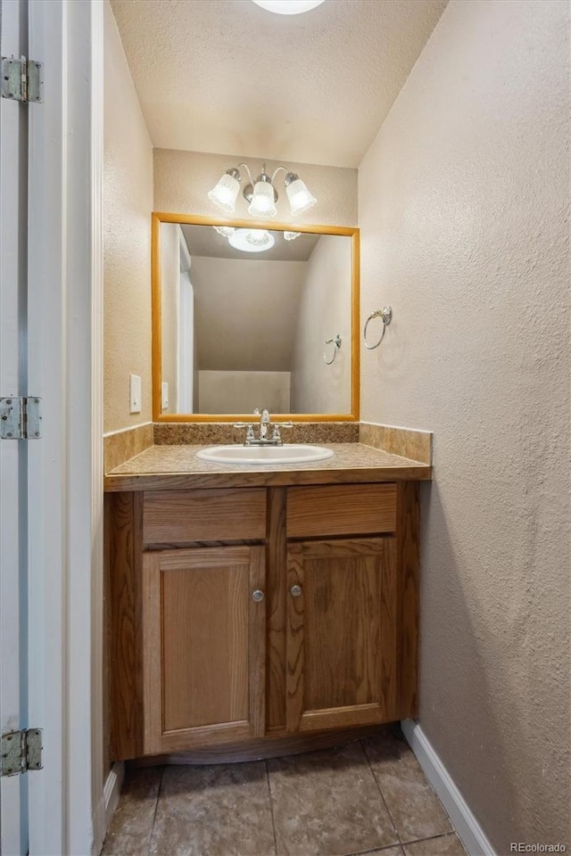 bathroom featuring vanity and a textured ceiling