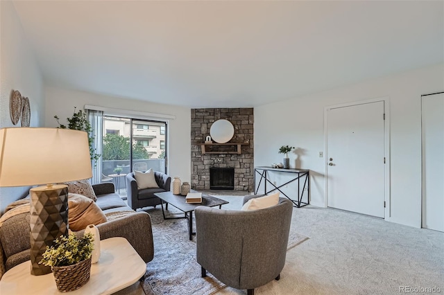 carpeted living room with a stone fireplace