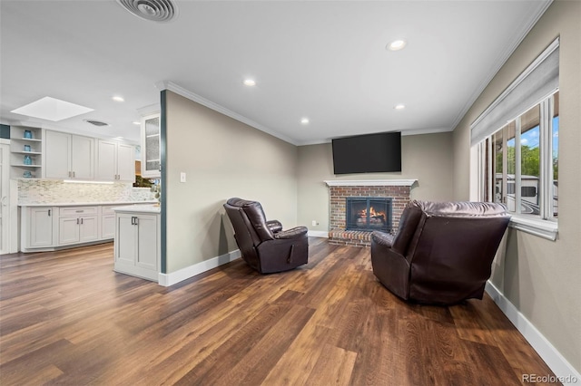 5320 W 62nd Ave, Arvada, CO 80003 - living area with a skylight, recessed lighting, dark wood-style floors, a brick fireplace, and crown molding