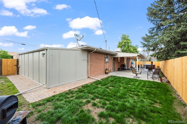 5320 W 62nd Ave, Arvada, CO 80003 - back of house with a patio area, a fenced backyard, brick siding, and a gate
