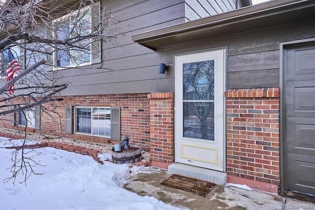 view of snow covered property entrance