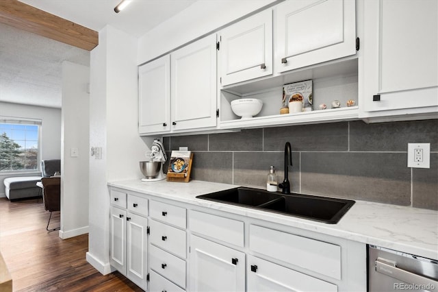 kitchen featuring white cabinetry, dishwasher, sink, and light stone countertops