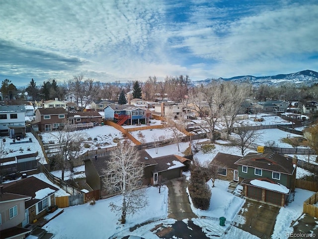 snowy aerial view featuring a mountain view