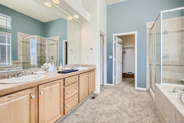 bathroom with shower with separate bathtub and vanity