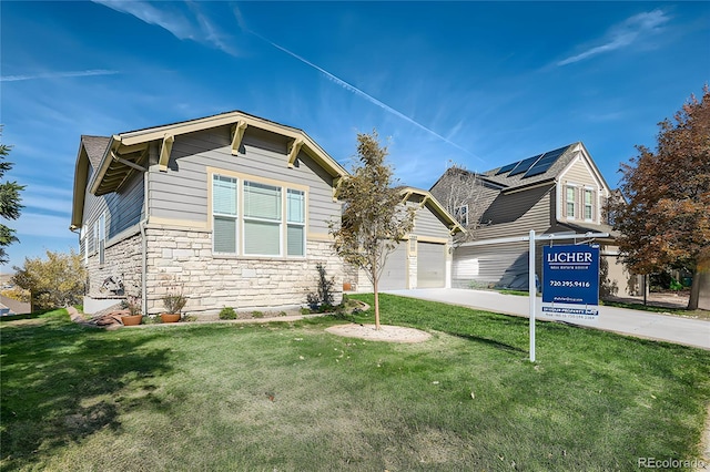 view of front facade featuring a front lawn and a garage