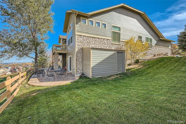 back of property featuring a lawn and a patio