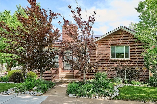 4000 Irving St, Denver, CO 80211 - view of front of property with brick siding, solar panels, and a chimney