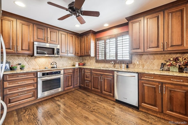 4000 Irving St, Denver, CO 80211 - kitchen featuring appliances with stainless steel finishes, dark wood-style flooring, tasteful backsplash, ceiling fan, and recessed lighting