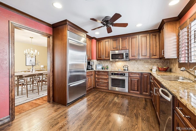 4000 Irving St, Denver, CO 80211 - kitchen featuring stainless steel appliances, dark wood finished floors, a sink, light stone countertops, and a ceiling fan