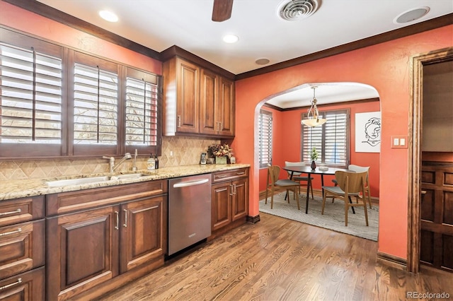 4000 Irving St, Denver, CO 80211 - kitchen featuring dishwasher, arched walkways, a sink, backsplash, and wood finished floors