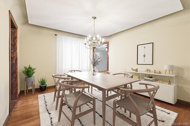 4000 Irving St, Denver, CO 80211 - dining room featuring baseboards, a chandelier, and wood finished floors