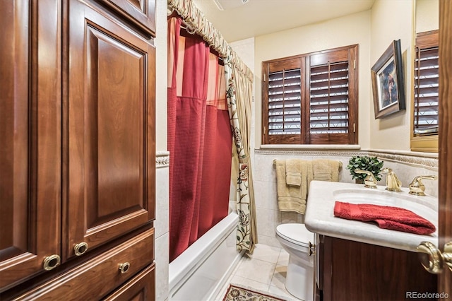 4000 Irving St, Denver, CO 80211 - bathroom with tile patterned floors, toilet, tile walls, vanity, and shower / bath combination with curtain