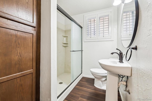 4000 Irving St, Denver, CO 80211 - full bathroom with a stall shower, toilet, wood finished floors, and baseboards