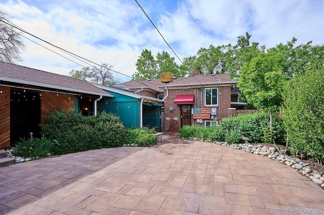 4000 Irving St, Denver, CO 80211 - view of front of home featuring brick siding and a patio area
