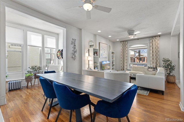 dining space with light wood finished floors, radiator heating unit, ceiling fan, and recessed lighting