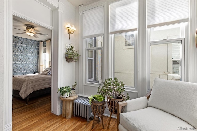 sunroom with radiator and ceiling fan