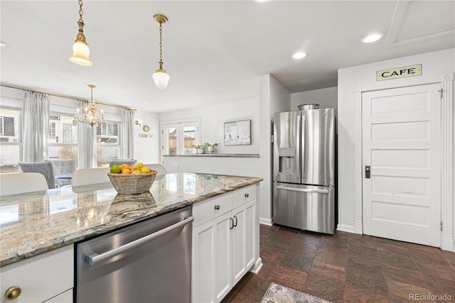 kitchen with light stone counters, recessed lighting, white cabinetry, appliances with stainless steel finishes, and decorative light fixtures