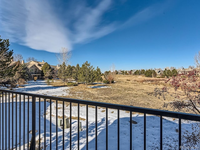 view of snow covered back of property