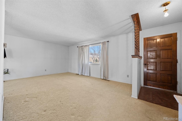 spare room with carpet and a textured ceiling