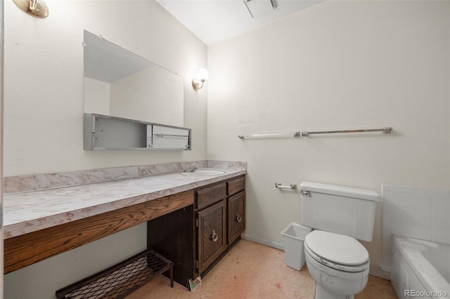 bathroom with vanity, toilet, baseboards, and a tub