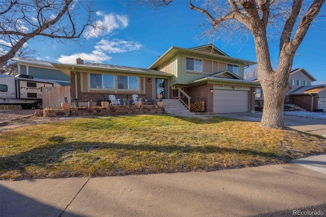 view of front of property with a front yard and a garage