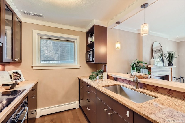 kitchen with baseboard heating, a sink, stainless steel appliances, wood finished floors, and visible vents