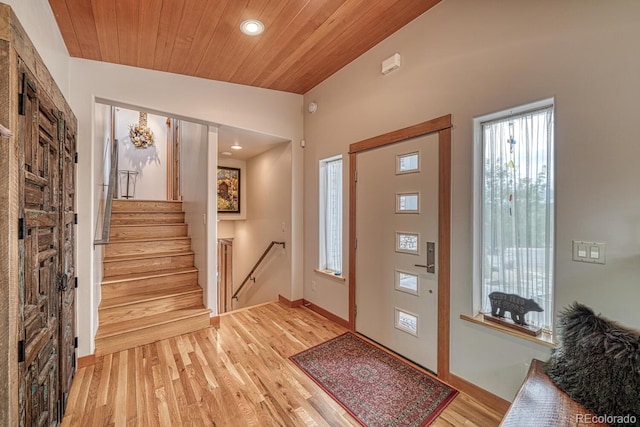 foyer entrance with light hardwood / wood-style floors, lofted ceiling, and wood ceiling