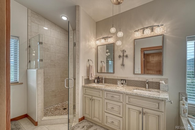 bathroom featuring tile patterned flooring, vanity, and walk in shower