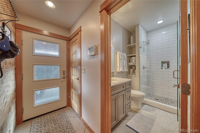 bathroom featuring vanity, toilet, a healthy amount of sunlight, and walk in shower