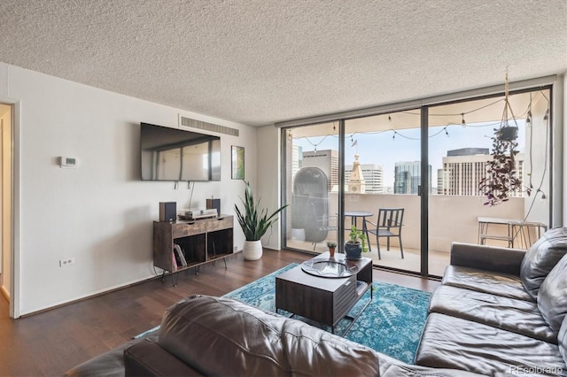 1020 15th St Unit 28G, Denver, CO 80202 - living room with wood finished floors, a textured ceiling, and expansive windows
